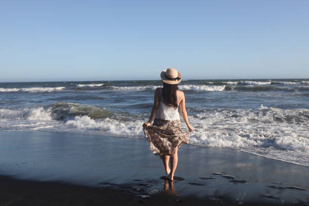 istock Beautiful young woman relaxing at sunset beach 1271880282