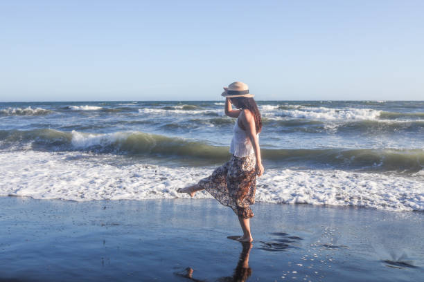 istock Beautiful young woman relaxing at sunset beach 1271880297