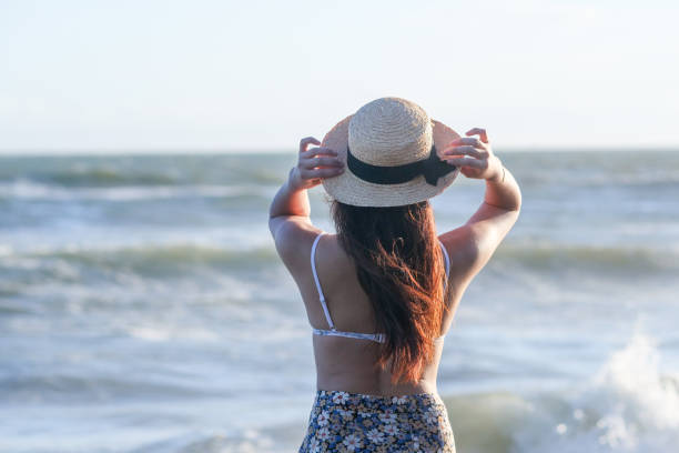 istock Beautiful young woman relaxing at sunset beach 1271880325