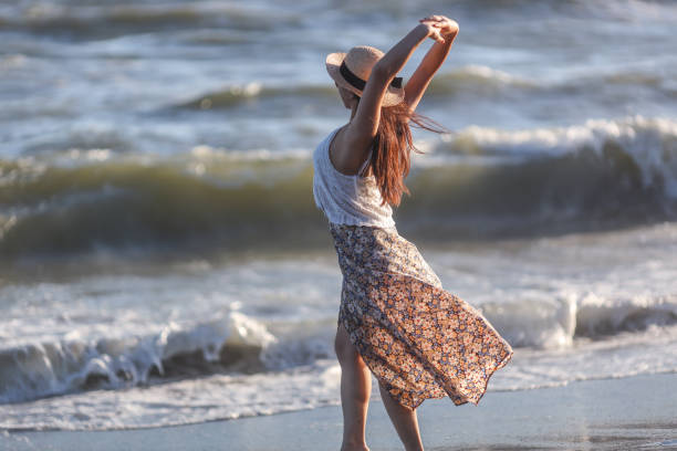 istock Beautiful young woman relaxing at sunset beach 1271880332