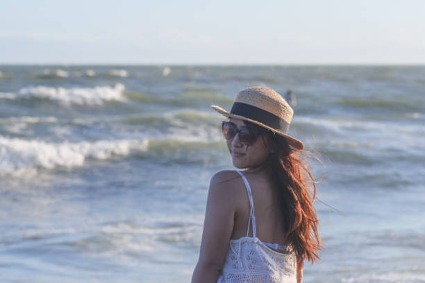 istock Beautiful young woman relaxing at sunset beach 1271880450