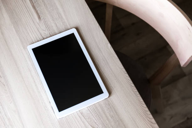 istock Office table with tablet pc and wooden chair. 1271882716