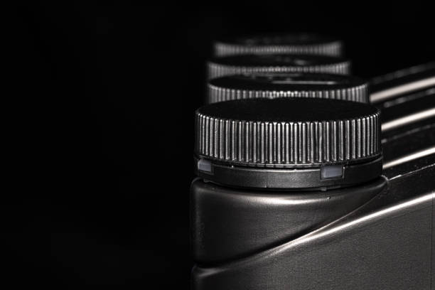 istock Engine oil bottle on black background, close up. 1271883135