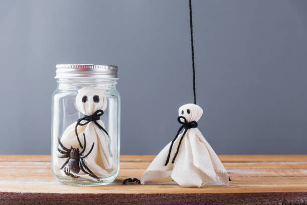 istock closeup white ghost and spider in jar on wooden 1271884143