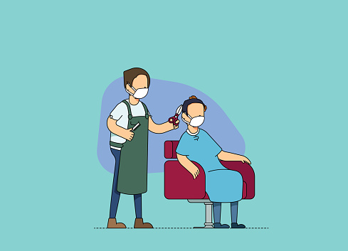 Male hairdresser and client at a hair salon, discussing and cutting hair. Adjusting to the new normal and social distancing norms, wearing mask at work.