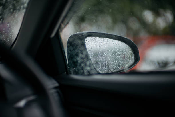 istock Side view mirror of a car on rainy day 1271889122
