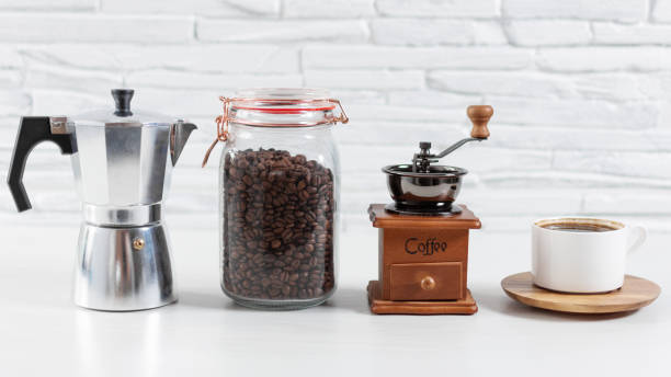 istock A cup of coffee and ingredients and equipment for making coffee on kitchen table.uns 1271889290