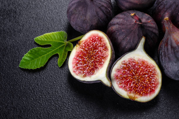 istock Fresh ripe figs on a dark concrete background. Harvesting figs 1271890767