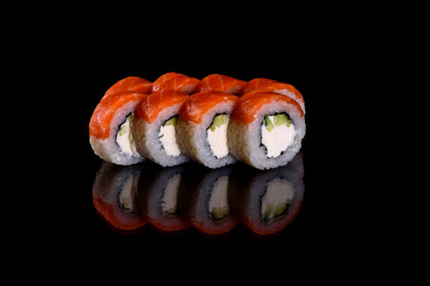 istock Fresh delicious beautiful sushi rolls on a dark background 1271893490