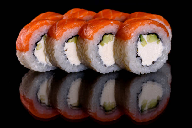 istock Fresh delicious beautiful sushi rolls on a dark background 1271893496