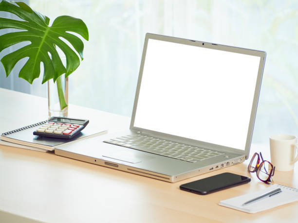 istock Laptop with blank screen mockup on table at home 1271893641
