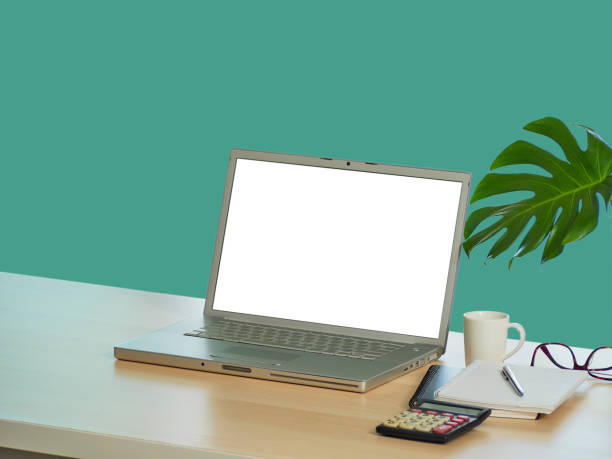 istock Laptop with blank screen mockup on table at home 1271893664