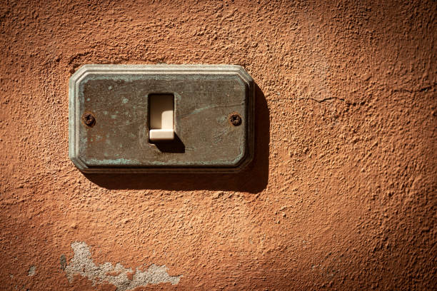 istock Old and rusty Light Switch on a red wall - Liguria Italy 1271894605