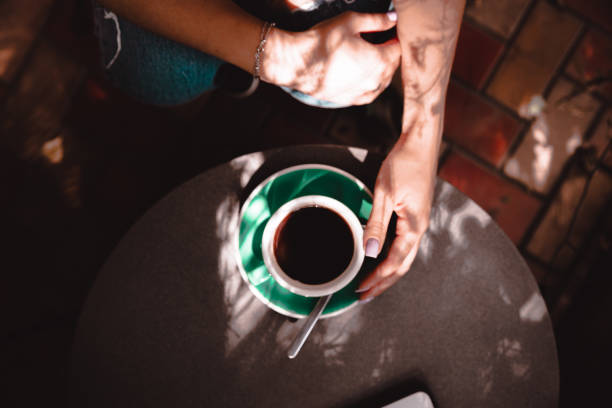 istock person with a cup of coffee 1271894752