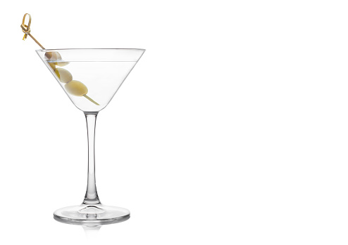 Vodka martini gin cocktail in classic glass with olives on bamboo stick on white background. Space for text