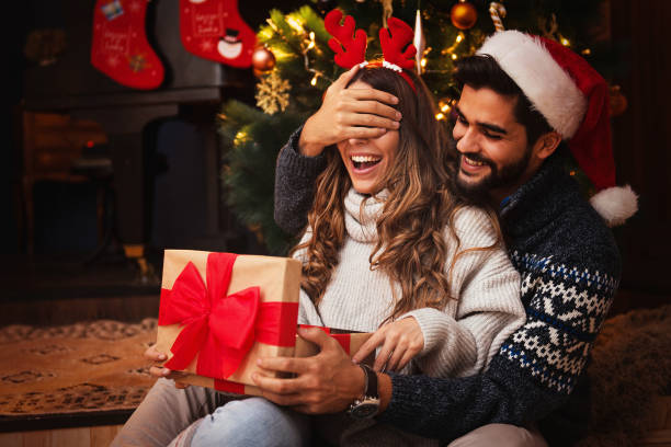 istock Man giving a Christmas present to his girlfriend 1271898965