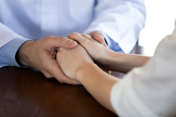 istock Close up caring supportive doctor holding young female patient hands 1271899063