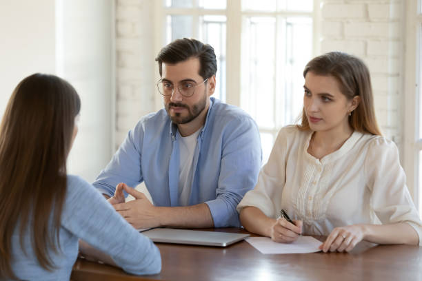 istock Two confident hr managers listening to candidate at job interview 1271899093