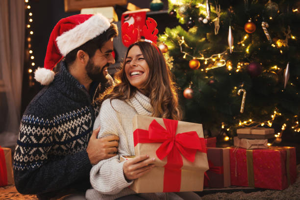 istock Man giving a Christmas present to his girlfriend 1271899585