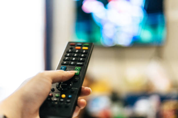 Hand Holding a Remote TV stock photo