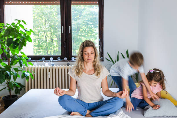 istock While noisy kids running young mother meditates 1271899765