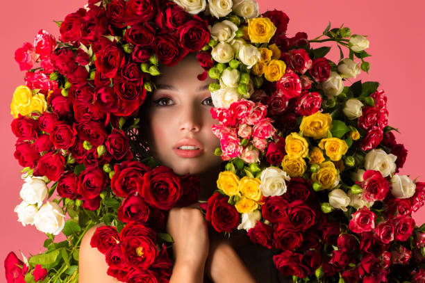 charming woman portrait with rose flowers cut out on pink background