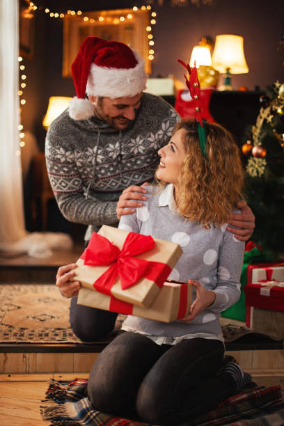 istock Man giving a Christmas present to his girlfriend 1271901997