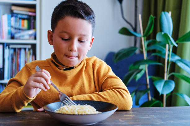 istock Child is eating spaghetti. He is very happy. 1271902068