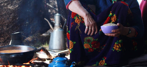 istock Bulgur pilaf cooked in wood fire. Nomad tent. 1271902707
