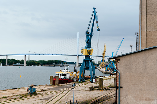Stralsund, Germany - July 31, 2019: View of the commercial harbour with cranes. Stralsund old town is a UNESCO World Heritage site