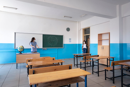 Teacher in the classroom attending an elementary class