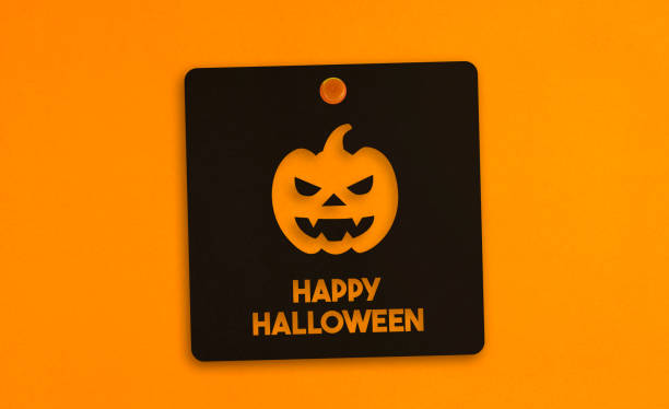 Halloween Concept Paper pinned in the orange background. Horizontal composition with copy space.