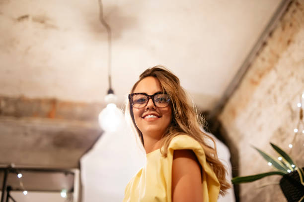 Portrait of young beautiful girl with glasses in photography studio. stock photo