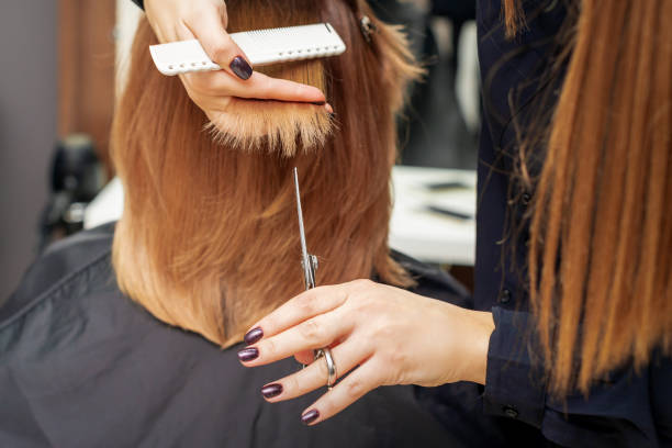 istock Hairdresser cuts red hair tips 1271905928
