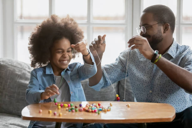 istock Happy little girl involved in handmade activity with caring father. 1271905936