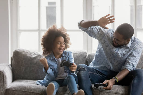 istock Young biracial father giving high five to daughter, celebrating win. 1271905963