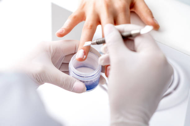 istock Process of applying acrylic powder on the nails 1271906113