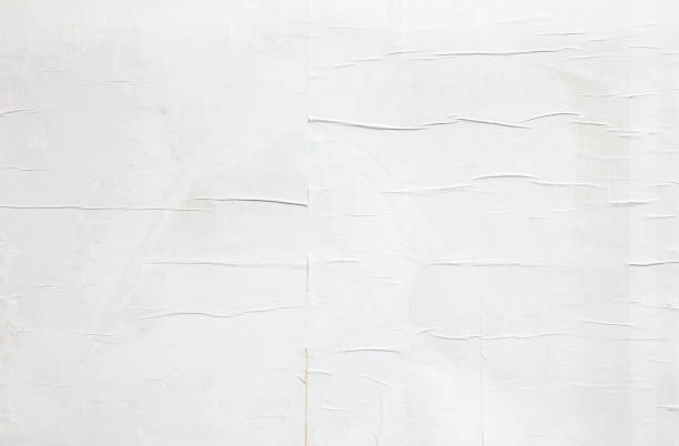 istock White dirty crumpled wavy paper posters glued on billboard texture background. 1271906646