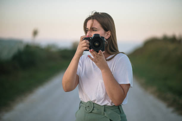 istock Young woman with a DSLR camera 1271908614