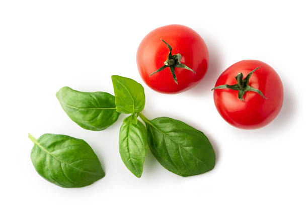 istock Ripe cherry tomatoes and basil  leaves isolated on white background. Top view. Clipping path 1271908693