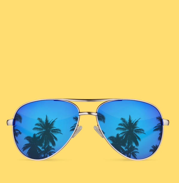 istock sunglasses with palms isolated on yellow background 1271914332