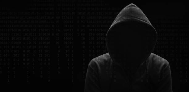 istock dark mysterious man in a hoodie is hiding his face, hacker, anonymous 1271914468