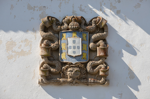 Old stone carved portuguese coat of arms from the historic village of Almeida, Portugal