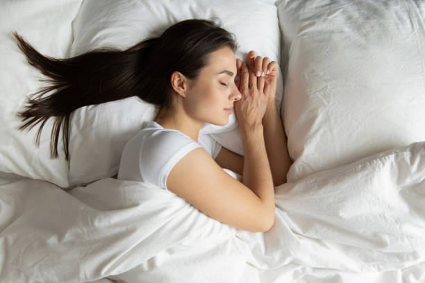 istock Top view beautiful young woman sleeping in cozy bed 1271917068