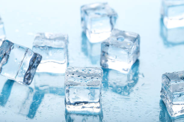istock Ice cubes with water drops on blue background 1271918311