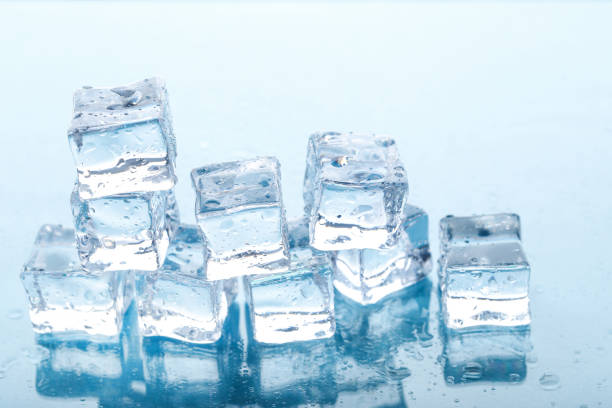 istock Ice cubes with water drops on blue background 1271918440