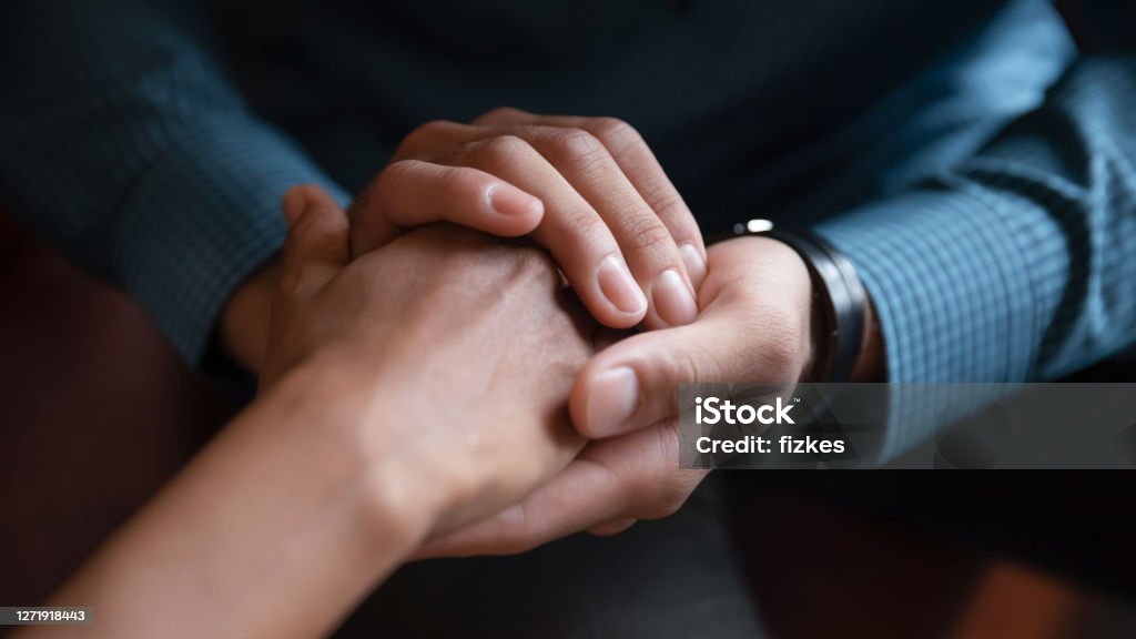 Close up African American man comforting woman, holding hands Close up African American man comforting woman, holding hands, expressing love and support, empathy, apologizing or saying sorry, family reconciliation, understanding in relationship Empathy Stock Photo