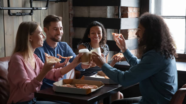 istock Happy diverse friends eating pizza and having fun in cafe 1271918892