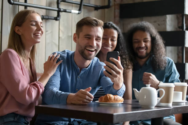 istock Overjoyed diverse people posing for photo in cafe together 1271918925