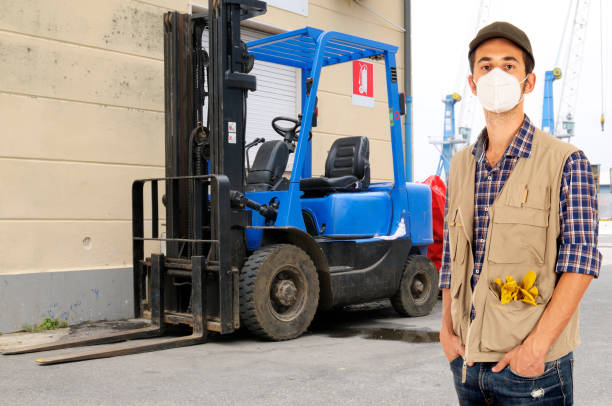 istock Young man forklift driver wearing anti virus mask during working 1271918970